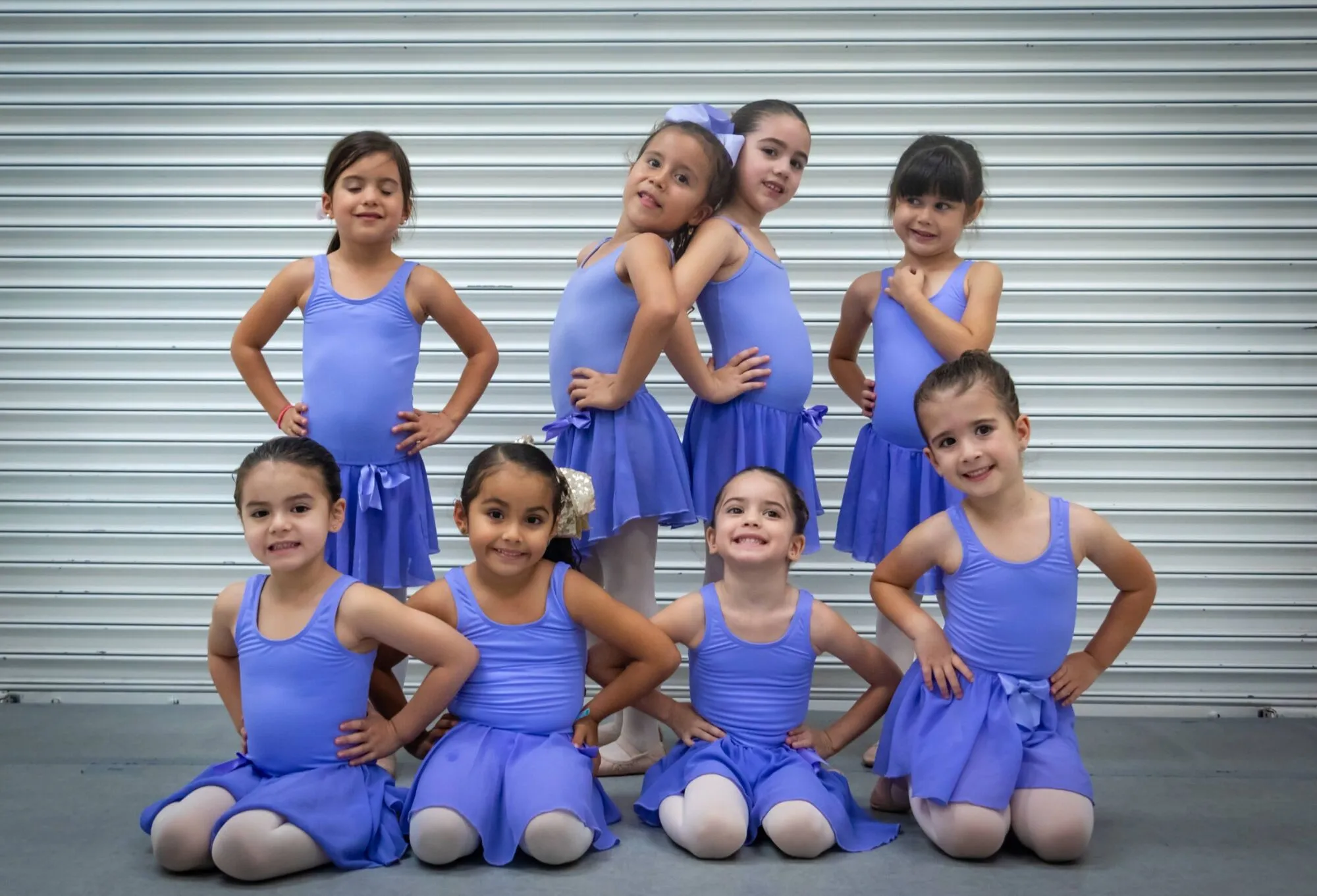 Nine young Candy Jazz Creative Dance students posing together in blue dancewear