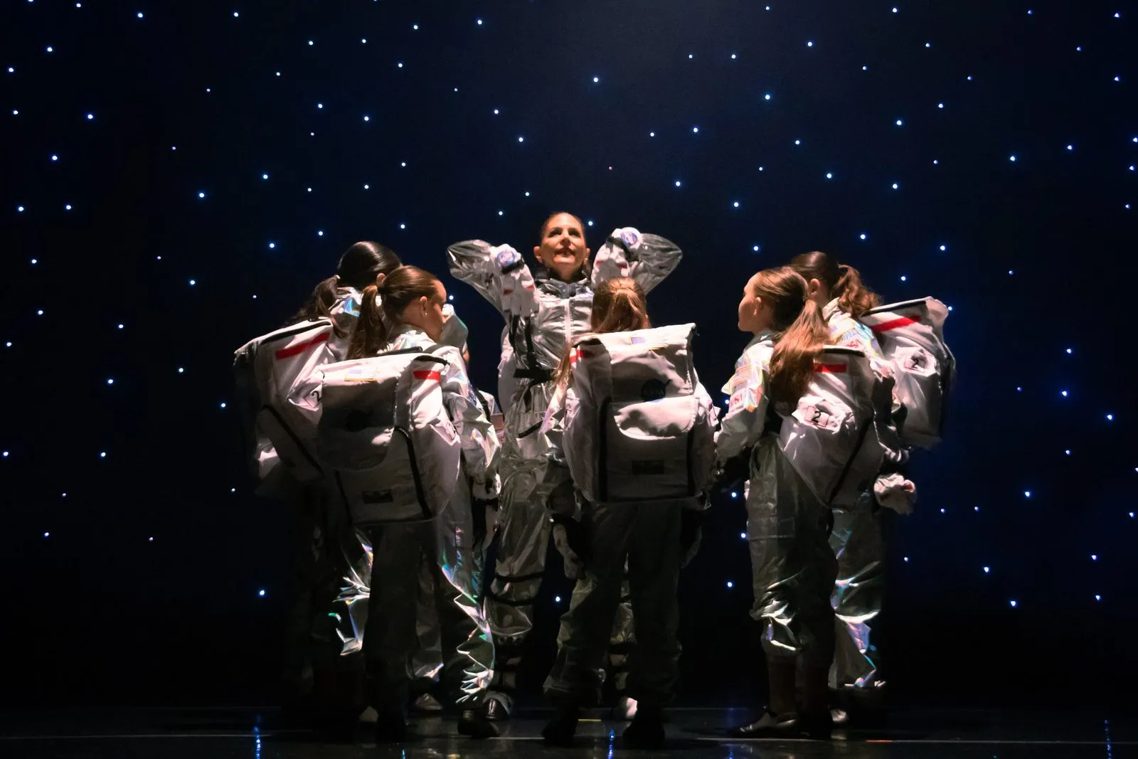 Candy Jazz dancers in silver costume on a lit stage